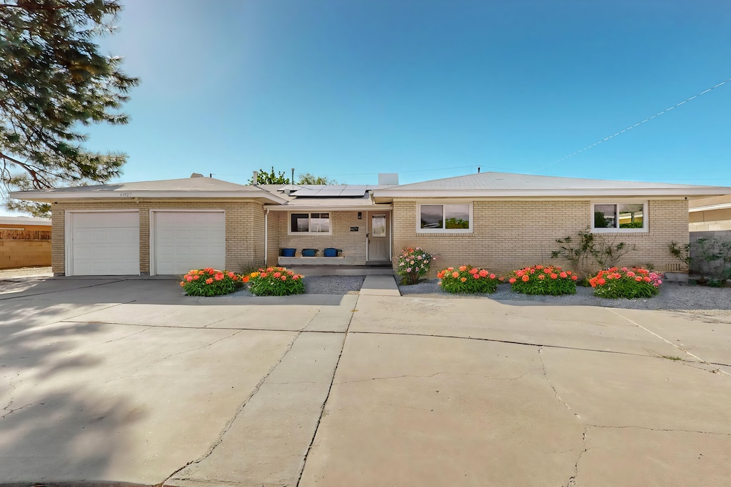 view of front facade with a garage and solar panels