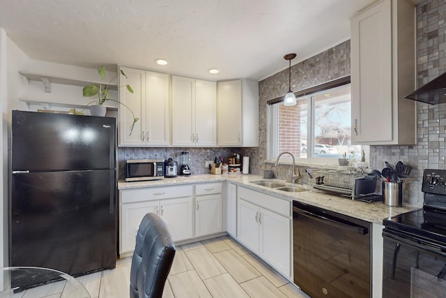 kitchen featuring black appliances, white cabinets, and tasteful backsplash