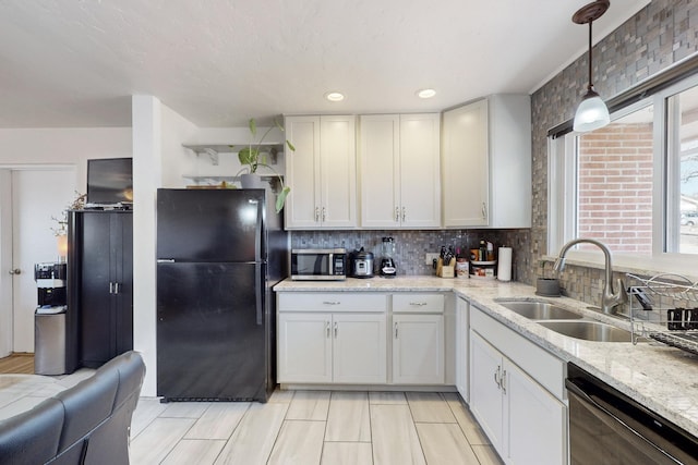 kitchen featuring sink, white cabinets, decorative backsplash, hanging light fixtures, and black appliances