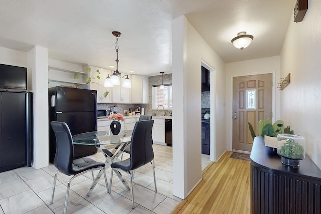 dining area with sink and light tile patterned floors