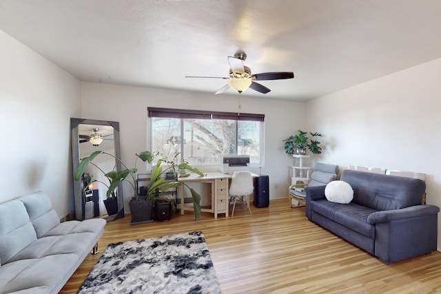 living room with light wood-type flooring and ceiling fan