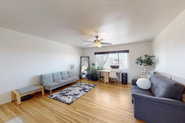 living room featuring ceiling fan and light wood-type flooring