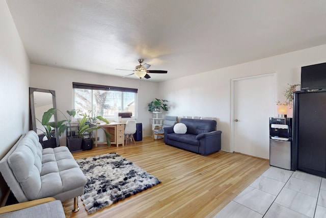 living room featuring ceiling fan and light hardwood / wood-style floors