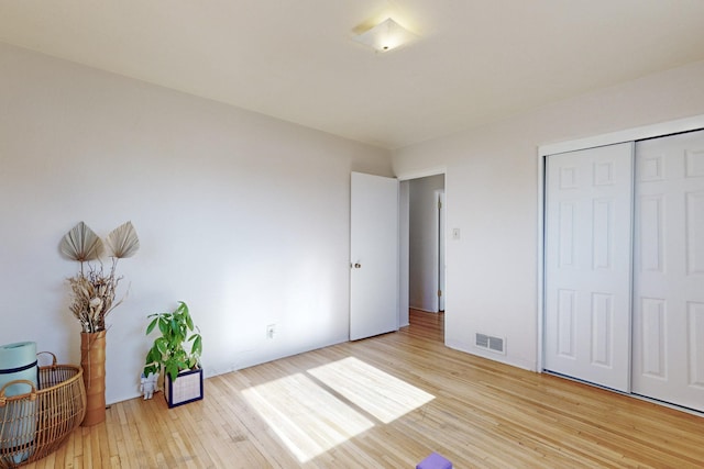 bedroom with a closet and light hardwood / wood-style floors