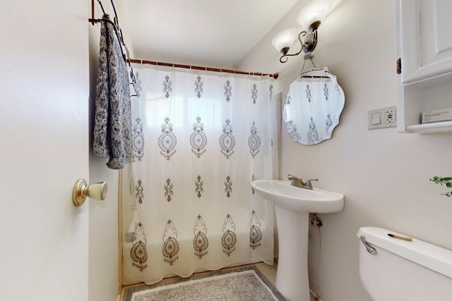 full bathroom with toilet, sink, and shower / bath combination with curtain