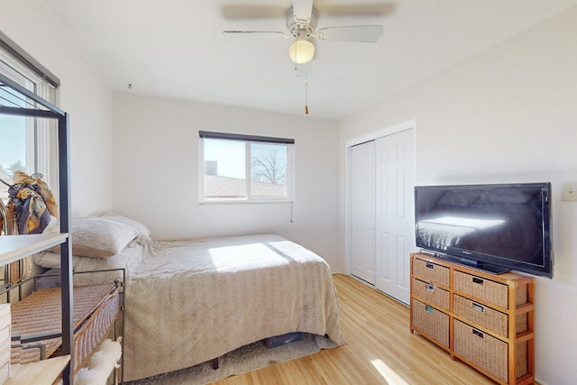 bedroom with a closet, ceiling fan, and light wood-type flooring