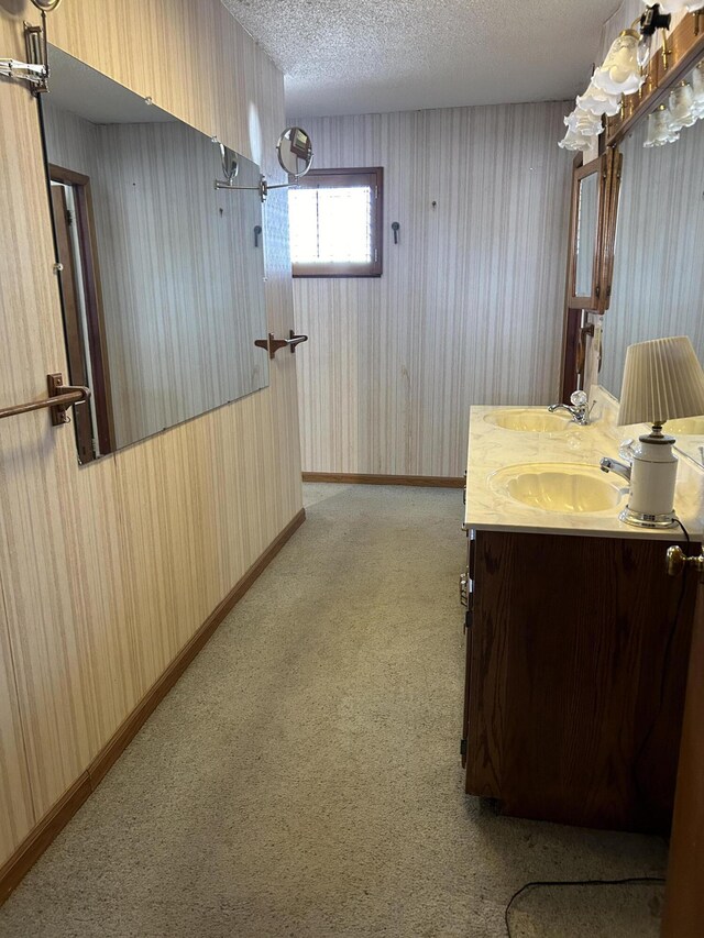 bathroom featuring a textured ceiling and oversized vanity