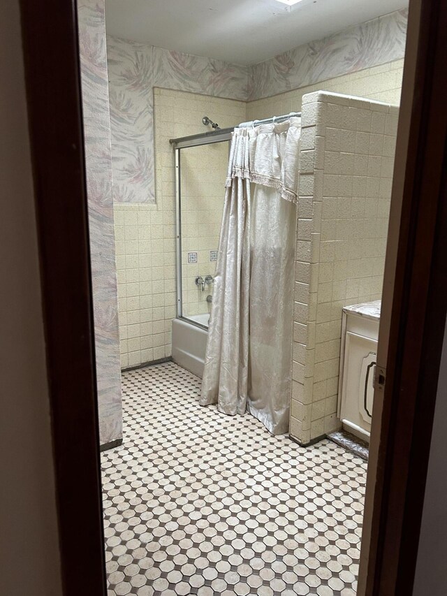 bathroom featuring tile floors and shower / bath combo with shower curtain