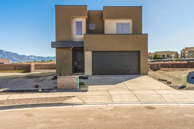 view of front facade featuring a garage and a mountain view