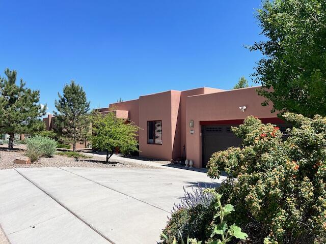 pueblo revival-style home featuring a garage