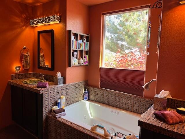 bathroom featuring a relaxing tiled bath and oversized vanity