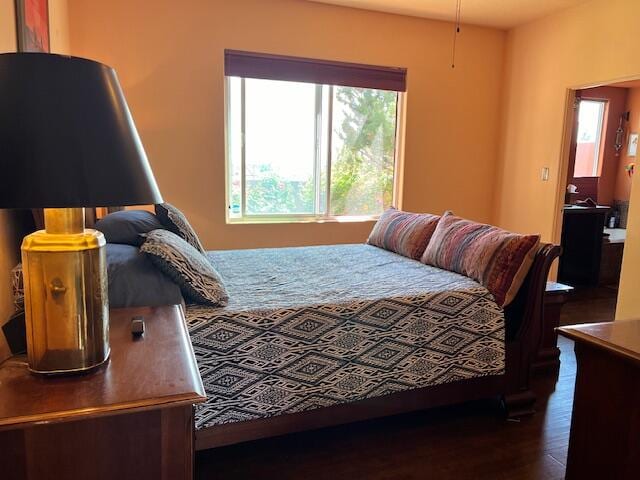 bedroom with dark wood-type flooring