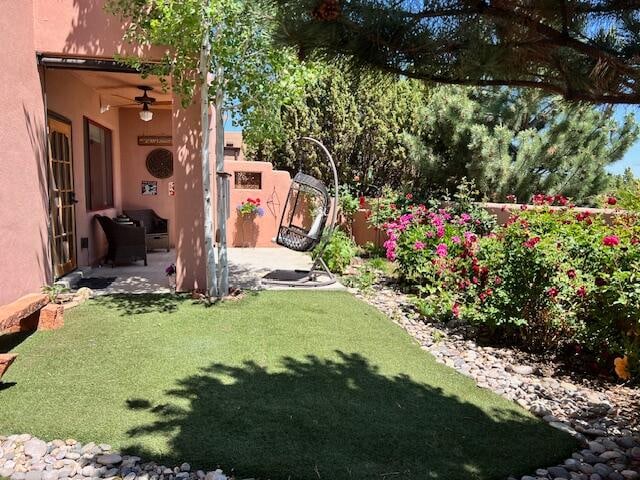 view of yard with a patio area and ceiling fan