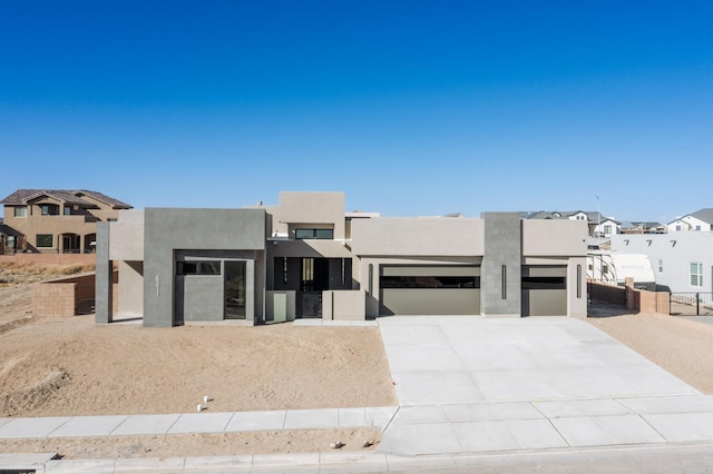 pueblo-style home featuring a garage