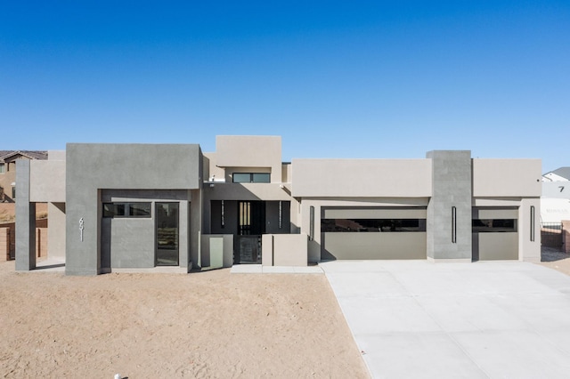 pueblo-style home featuring a garage