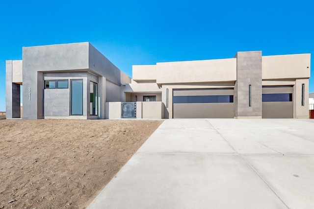 pueblo-style house featuring a garage