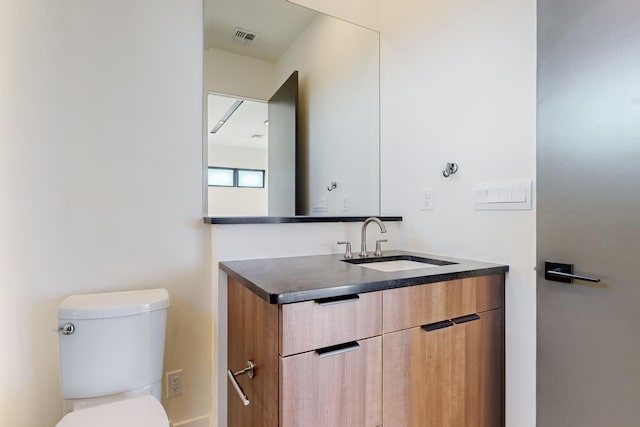 bathroom featuring vanity and toilet