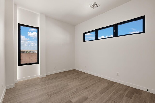 unfurnished room with plenty of natural light and light wood-type flooring