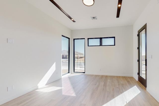 unfurnished room with a healthy amount of sunlight and light wood-type flooring