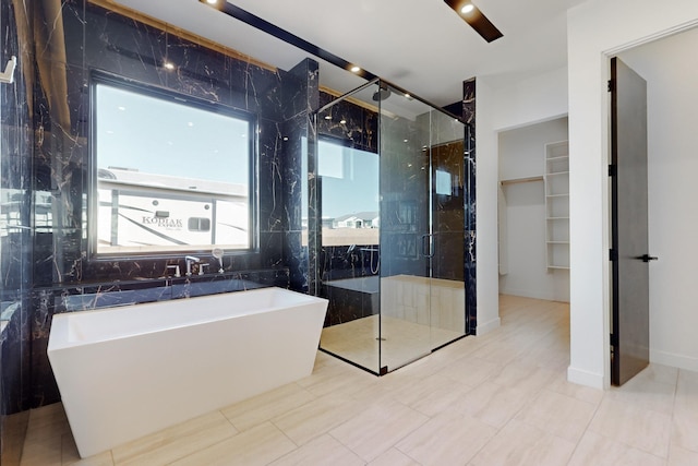 bathroom featuring shower with separate bathtub