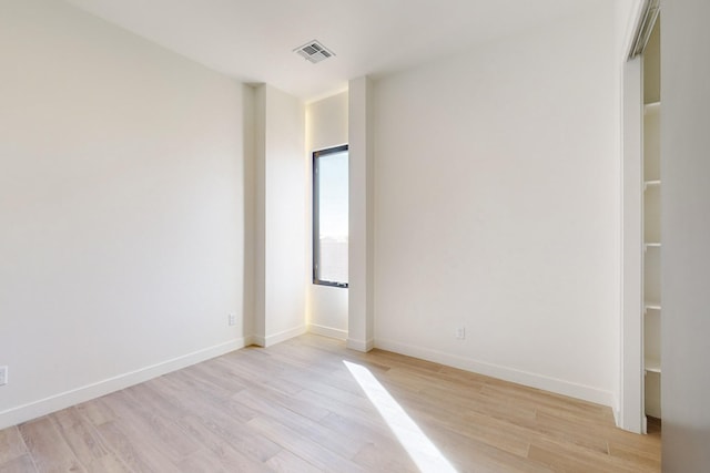 spare room featuring light wood-type flooring