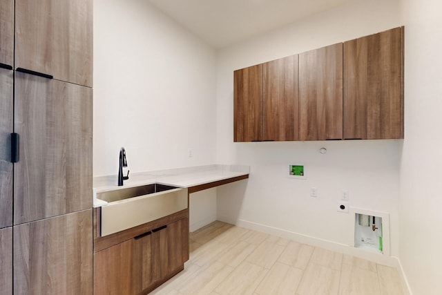 clothes washing area with sink, cabinets, hookup for a gas dryer, hookup for a washing machine, and electric dryer hookup