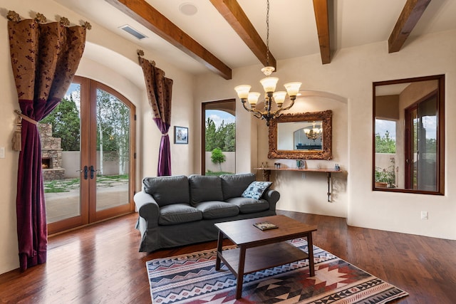 living room with beam ceiling, hardwood / wood-style flooring, french doors, and an inviting chandelier