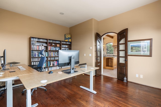 home office with dark hardwood / wood-style floors