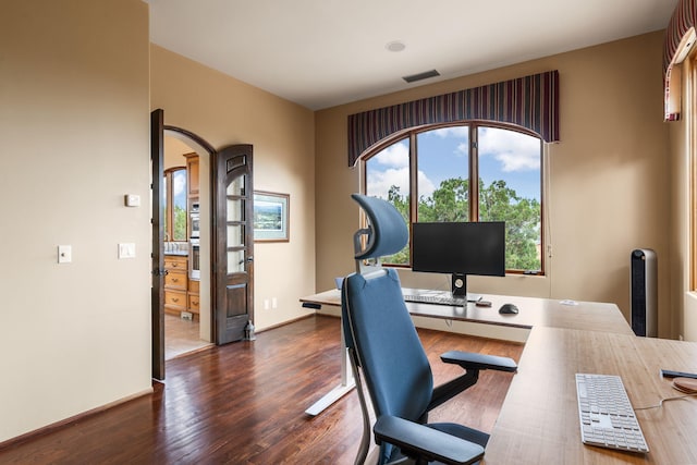 office space with dark wood-type flooring