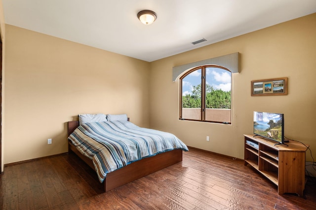 bedroom featuring dark hardwood / wood-style flooring