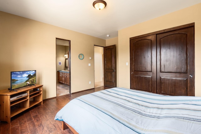 bedroom featuring dark wood-type flooring, connected bathroom, and a closet