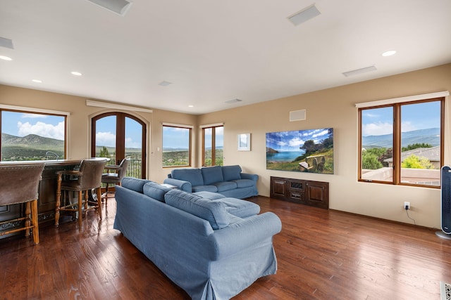 living room with a mountain view, dark hardwood / wood-style floors, and french doors