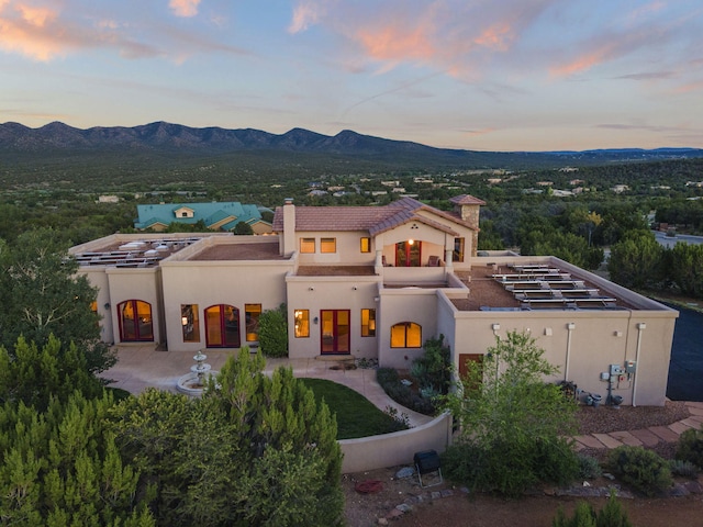 mediterranean / spanish house featuring a mountain view and a patio