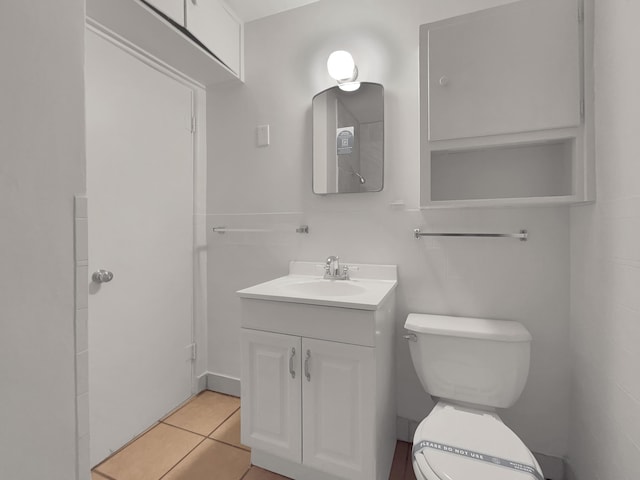 bathroom featuring tile patterned flooring, vanity, and toilet