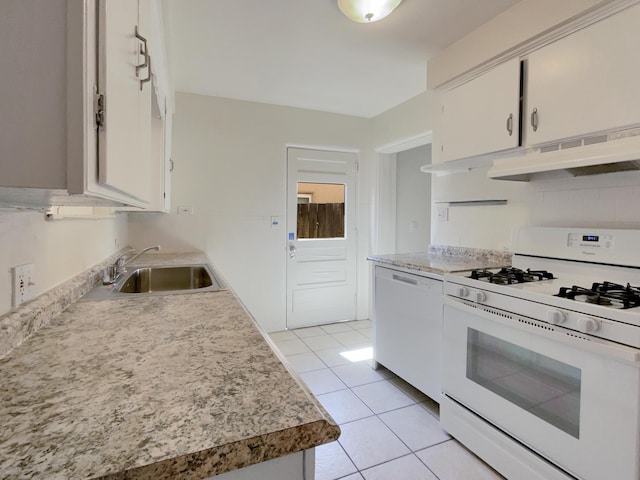 kitchen with white appliances, exhaust hood, sink, light tile patterned floors, and white cabinets