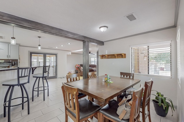 dining area with beamed ceiling, light tile patterned flooring, crown molding, and french doors