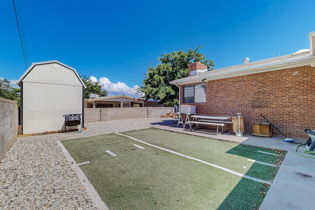 view of yard with a patio area and a storage shed