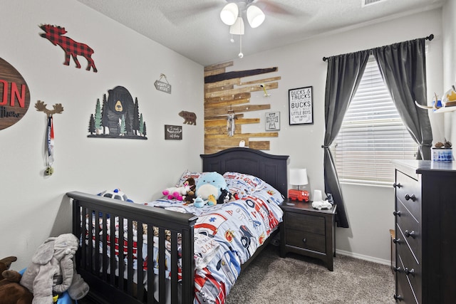 bedroom featuring a textured ceiling, ceiling fan, and light carpet