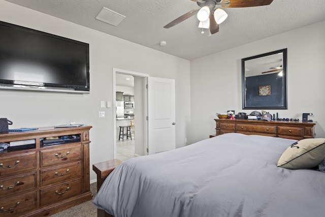 bedroom featuring a textured ceiling and ceiling fan