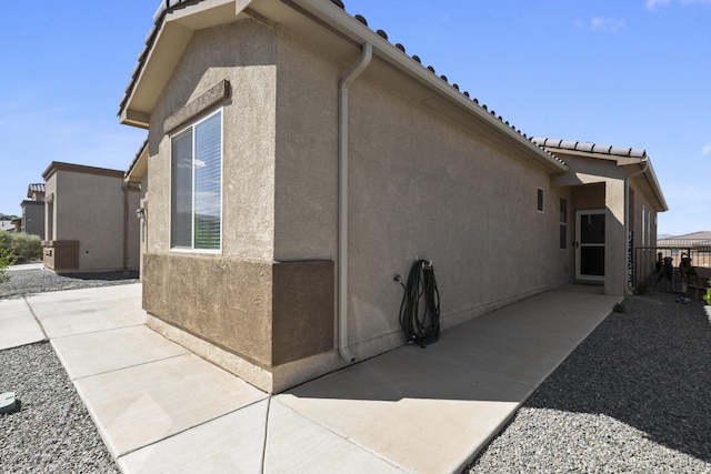 view of side of property with a patio