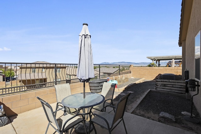 view of patio / terrace with a mountain view and a pergola