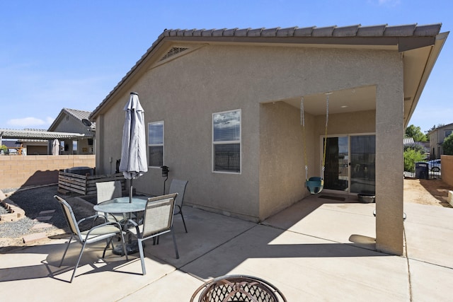 back of property with a patio