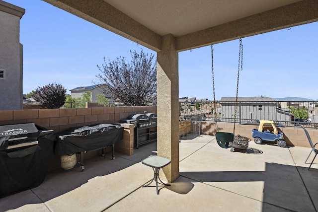 view of patio featuring a fire pit and area for grilling