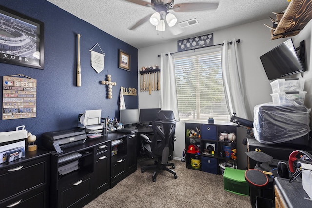 carpeted office featuring a textured ceiling and ceiling fan