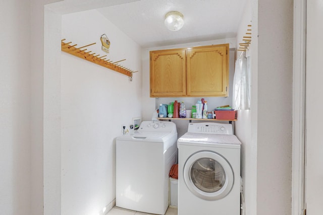 laundry area featuring cabinets, separate washer and dryer, and light tile patterned floors