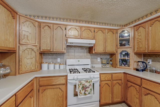 kitchen featuring backsplash, white range with gas cooktop, and a textured ceiling