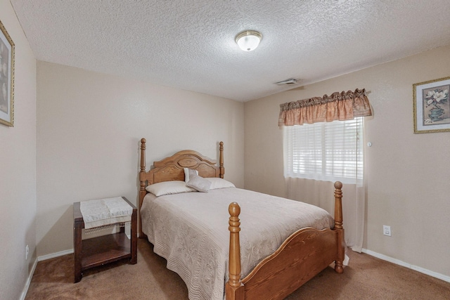 bedroom featuring carpet flooring and a textured ceiling