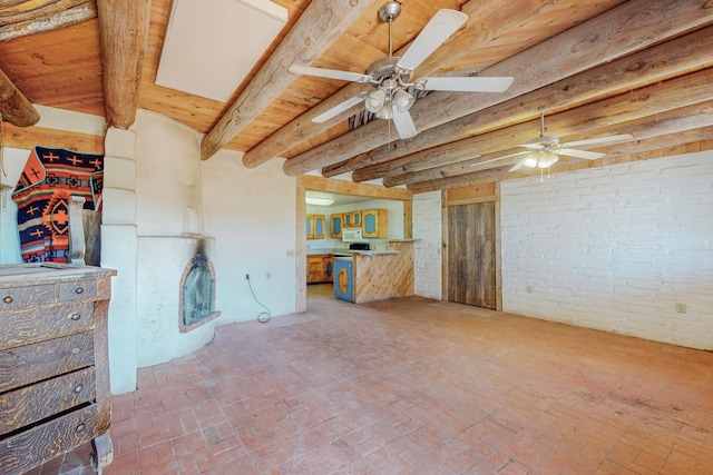 interior space with brick wall, wooden ceiling, and ceiling fan