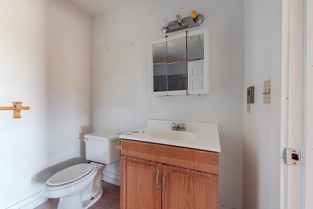 bathroom featuring tile patterned floors, toilet, and vanity