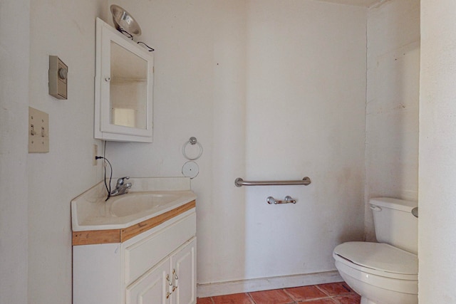 bathroom featuring vanity, tile patterned flooring, and toilet